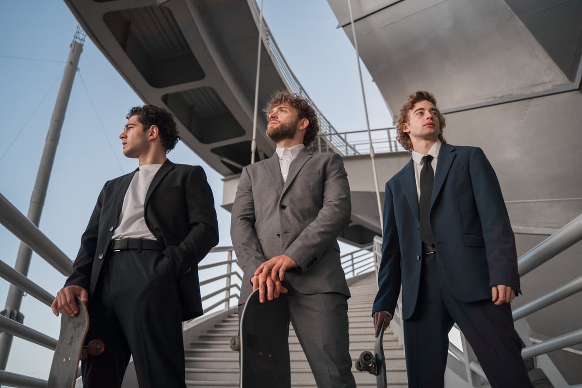 Men in Business Attire Holding Their Skateboards